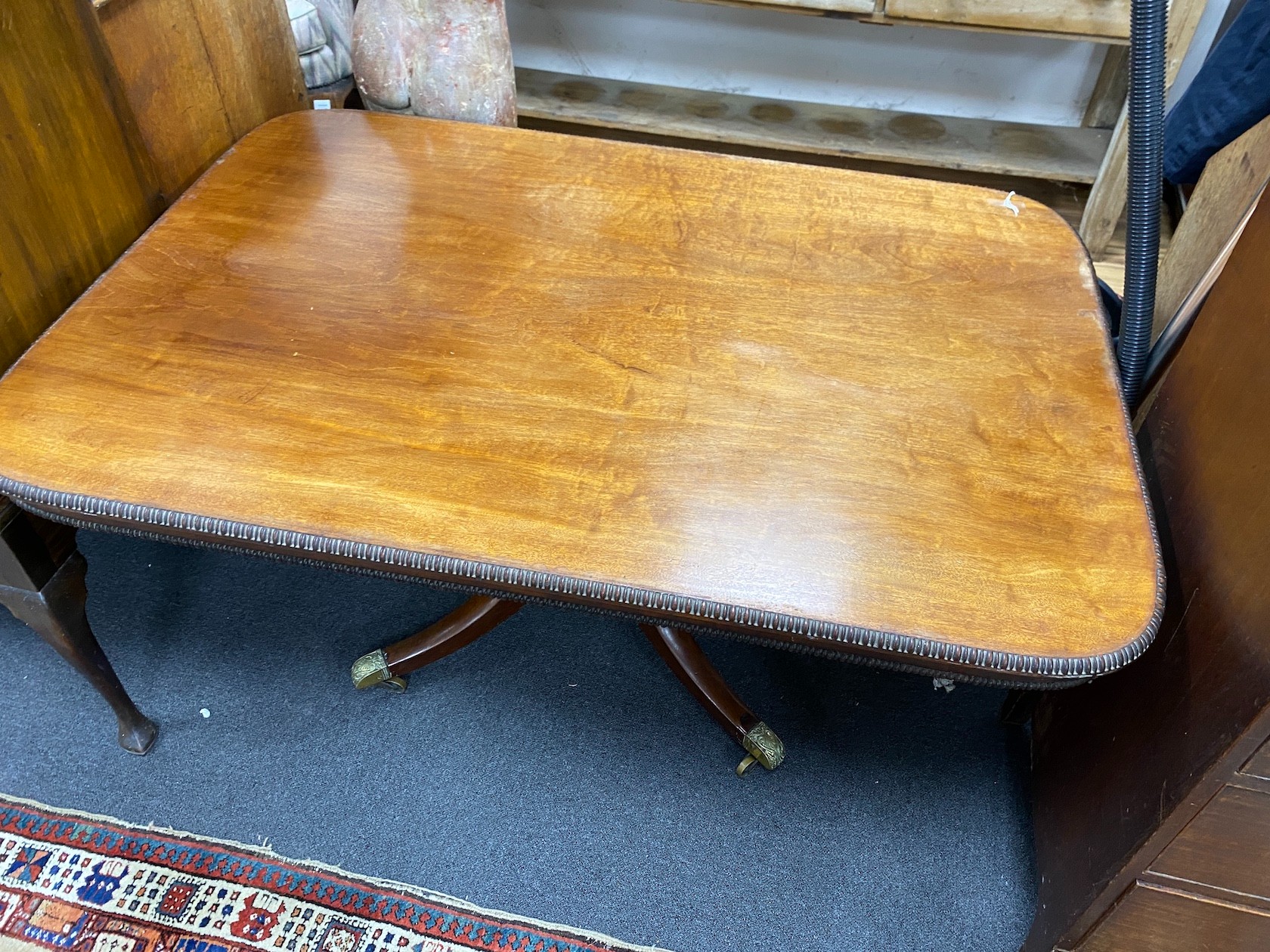 A Regency rectangular mahogany tilt top dining table, length 136cm, width 94cm, height 71cm